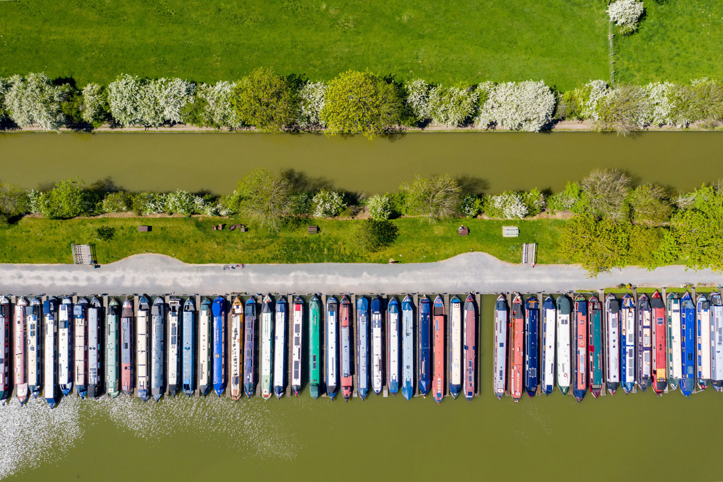 Canal boats lining the Grand Union Canal at Crick, Northamptonshire. They can only be used for essential travel. © Geoff Robinson